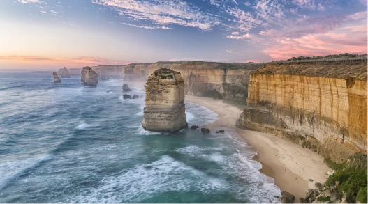 a beach with a few rocks and water